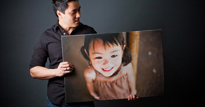 man holding the photograph of a girl