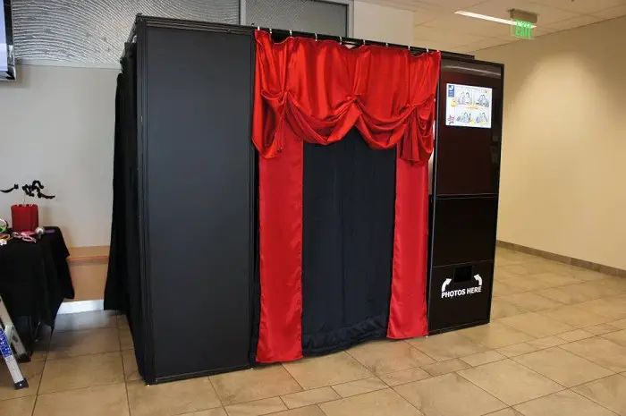 black photo booth with red courtains