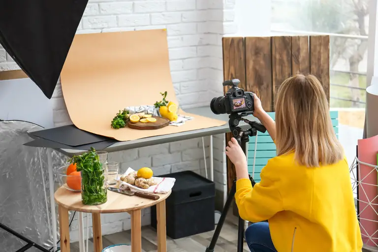 young woman taking picture of lemons